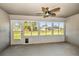 A sunroom featuring a ceiling fan and large sliding windows providing beautiful light at 25259 Alcazar Dr, Punta Gorda, FL 33955