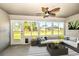 A sunroom featuring a ceiling fan, outdoor seating, a rug, and large sliding windows at 25259 Alcazar Dr, Punta Gorda, FL 33955