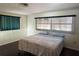 Cozy bedroom with a queen-sized bed, dark wood floors, and bright natural light from the window at 2837 Woodcrest Dr, Sarasota, FL 34239