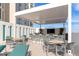 Outdoor poolside bar with shaded seating and a TV at 301 Quay Cmn # 1005, Sarasota, FL 34236