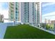 Rooftop deck with artificial grass and building exterior at 301 Quay Cmn # 1005, Sarasota, FL 34236