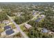 Aerial neighborhood view of tree-lined streets and established homes with mature landscaping in a verdant community at 3189 Seattle Ave, North Port, FL 34286