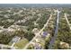 Neighborhood aerial view of homes with mature landscaping and tree coverage near winding canal at 3189 Seattle Ave, North Port, FL 34286