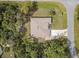 Aerial view of property featuring a well-maintained roof, long driveway, and landscaped yard with mature trees at 3189 Seattle Ave, North Port, FL 34286