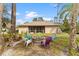 Backyard area features a cozy fire pit with colorful Adirondack chairs, perfect for outdoor entertaining at 3189 Seattle Ave, North Port, FL 34286