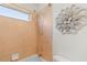 Close up on combination shower and tub with decorative flower hanging on the wall at 3189 Seattle Ave, North Port, FL 34286