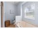 Bathroom featuring a soaking tub with marble surround and a toilet and woven trashcan at 3189 Seattle Ave, North Port, FL 34286