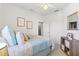 Bedroom with light colored carpet, queen bed and decorative pillows and pictures on the wall at 3189 Seattle Ave, North Port, FL 34286