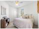 Bedroom with double closet, ceiling fan and queen bed with decorative pillows at 3189 Seattle Ave, North Port, FL 34286