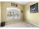 This cozy bedroom has a large window, light yellow walls, and Kennesaw State University decor at 3189 Seattle Ave, North Port, FL 34286