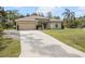 Well-maintained home with a large driveway and lush green lawn at 3189 Seattle Ave, North Port, FL 34286