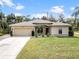 Charming single-story home featuring a two-car garage and beautiful landscaping at 3189 Seattle Ave, North Port, FL 34286