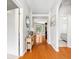 Inviting hallway with wood floors, leading to a bright living area at 3189 Seattle Ave, North Port, FL 34286
