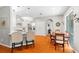 Open-concept kitchen with white cabinets, stainless steel appliances, and hardwood flooring at 3189 Seattle Ave, North Port, FL 34286