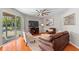 Comfortable living room with a large TV and sliding glass doors at 3189 Seattle Ave, North Port, FL 34286