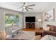 Spacious living room with a ceiling fan and access to the outdoor patio at 3189 Seattle Ave, North Port, FL 34286