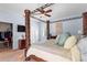 Bright and airy main bedroom featuring a four poster bed, dresser and walk-in closet at 3189 Seattle Ave, North Port, FL 34286