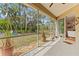 A screened patio with a view of the backyard and an outdoor seating area at 3189 Seattle Ave, North Port, FL 34286