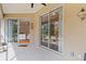 A covered patio area with sliding glass doors leading to the home's interior at 3189 Seattle Ave, North Port, FL 34286
