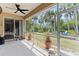 A spacious screened patio offering a view of the lush backyard and comfortable outdoor seating at 3189 Seattle Ave, North Port, FL 34286