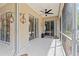 A well-lit covered patio area with sliding glass doors and access to a screened-in portion at 3189 Seattle Ave, North Port, FL 34286