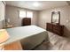 Neutral bedroom featuring wood-look floors, window and wooden furnishings at 3231 Sweet Bay Ter, Sarasota, FL 34237