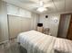 Neutral bedroom featuring wood-look floors, window, and TV at 3231 Sweet Bay Ter, Sarasota, FL 34237