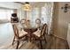 Charming dining area featuring a glass-top table, wicker chairs, and natural light from the nearby windows at 3231 Sweet Bay Ter, Sarasota, FL 34237