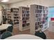 A well-stocked community library with multiple bookshelves and round tables at 3231 Sweet Bay Ter, Sarasota, FL 34237