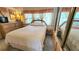 A well-lit bedroom features a comfortable bed, matching furnishings, and a full-length mirror at 3333 26Th E Ave # 28, Bradenton, FL 34208