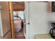 View from hallway into cozy bedroom with neutral decor and a glimpse of natural light at 3333 26Th E Ave # 28, Bradenton, FL 34208