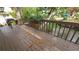 Wooden deck overlooking the water, with a small table and chair set surrounded by lush foliage at 3333 26Th E Ave # 28, Bradenton, FL 34208