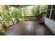 Exterior deck with wood flooring complemented by the natural surroundings, potted plants at 3333 26Th E Ave # 28, Bradenton, FL 34208