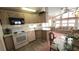 A fully equipped kitchen features matching appliances and an adjacent living area with natural light at 3333 26Th E Ave # 28, Bradenton, FL 34208