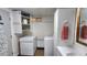 Bright laundry room with modern washer and dryer, plus overhead cabinets for organized storage at 3333 26Th E Ave # 28, Bradenton, FL 34208
