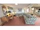 Spacious living room with comfortable seating, including a floral sofa, a desk and dining area, creating a cozy and inviting space at 3333 26Th E Ave # 28, Bradenton, FL 34208