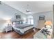 Bedroom with a bed dressed in modern patterned linens and wicker furnishings at 3815 Muirfield Ct, Palm Harbor, FL 34685