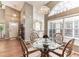 Open dining room features bright light, modern flooring, and stylish chairs at 3815 Muirfield Ct, Palm Harbor, FL 34685