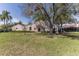Beautiful one-story home featuring a lush front lawn and a serene residential setting at 3815 Muirfield Ct, Palm Harbor, FL 34685