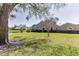 Charming single-story home with a well-manicured front lawn and water view at 3815 Muirfield Ct, Palm Harbor, FL 34685