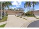 Charming home featuring a tile roof, attached two-car garage, and lush landscaping at 3815 Muirfield Ct, Palm Harbor, FL 34685