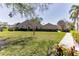 Charming single-story home with a well-manicured lawn and landscaped garden at 3815 Muirfield Ct, Palm Harbor, FL 34685