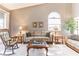 Comfortable living room boasts vaulted ceiling, natural light, and a neutral palette at 3815 Muirfield Ct, Palm Harbor, FL 34685