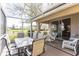 Enjoy the scenic pond view from this screened patio with dining and lounge seating at 3815 Muirfield Ct, Palm Harbor, FL 34685