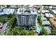 Stunning aerial view of modern condo building surrounded by lush landscaping and a pool at 401 S Palm Ave # 801, Sarasota, FL 34236