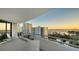 Spacious balcony with seating and waterfront views of boats, city buildings, and sunset at 401 S Palm Ave # 801, Sarasota, FL 34236