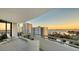 Balcony view of the city, clear blue water, and condo building at sunset at 401 S Palm Ave # 801, Sarasota, FL 34236