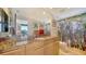 Bright bathroom featuring marble countertops, contemporary fixtures, and a decorative tropical-themed shower curtain at 401 S Palm Ave # 801, Sarasota, FL 34236