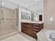 Modern bathroom with a walk-in shower and vanity with a dark wood finish at 401 S Palm Ave # 801, Sarasota, FL 34236