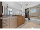 Bathroom featuring marble countertops, wooden cabinets, a shower with glass enclosure, and tiled floor at 401 S Palm Ave # 801, Sarasota, FL 34236